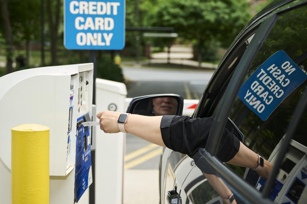 Driver taking a ticket from the machine